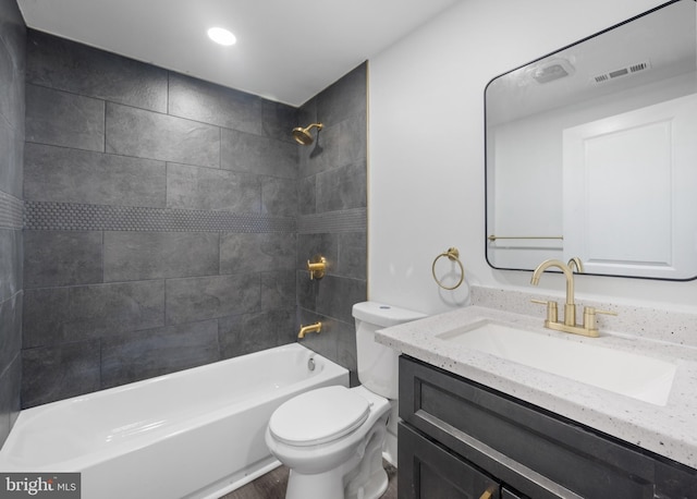 full bathroom with vanity, toilet, and tiled shower / bath