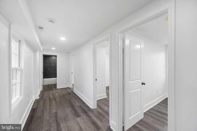 hallway with dark hardwood / wood-style floors