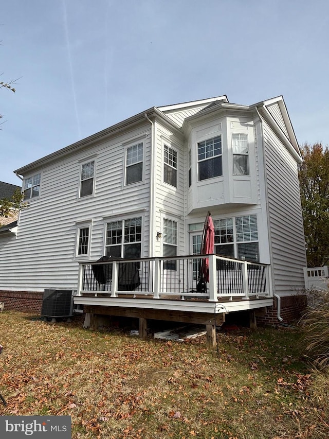 rear view of property featuring central AC and a deck