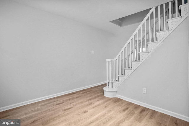 stairs with hardwood / wood-style flooring