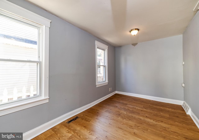 spare room with hardwood / wood-style flooring