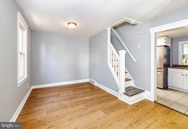 staircase with hardwood / wood-style floors