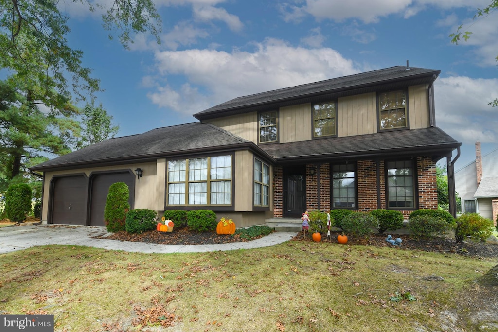 view of front of home with a garage and a front lawn