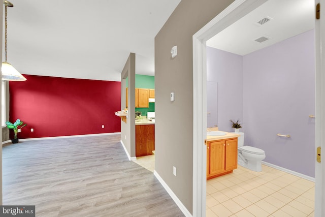 bathroom with hardwood / wood-style floors, vanity, and toilet