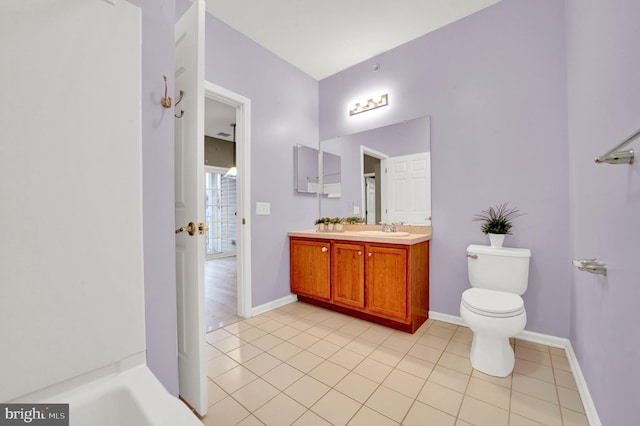 bathroom featuring toilet, vanity, and tile patterned floors