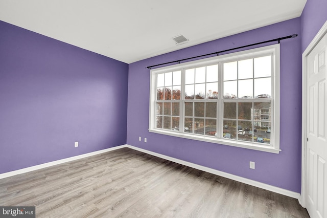 unfurnished room with light wood-type flooring