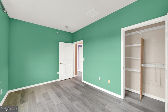 unfurnished bedroom featuring a closet and light hardwood / wood-style flooring