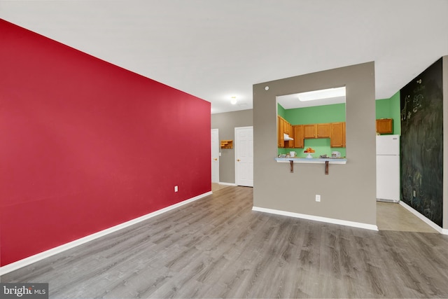 unfurnished living room with light hardwood / wood-style floors