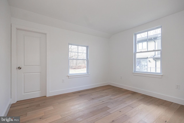 empty room with light wood-type flooring and plenty of natural light