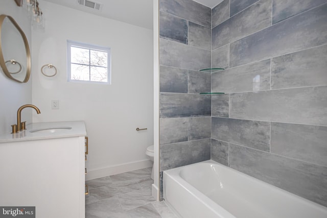 full bathroom featuring vanity, toilet, and tiled shower / bath combo