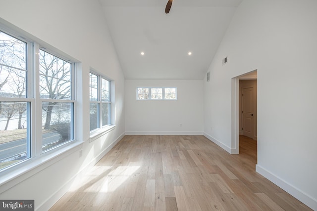 unfurnished room featuring ceiling fan, light hardwood / wood-style flooring, and high vaulted ceiling