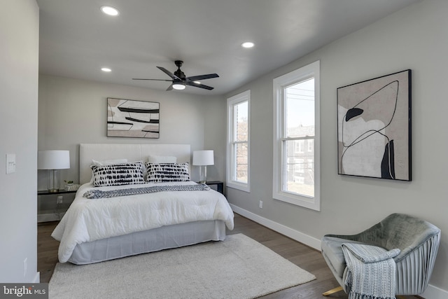 bedroom with ceiling fan and dark wood-type flooring