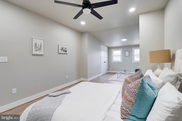 bedroom featuring light hardwood / wood-style floors, ceiling fan, and lofted ceiling