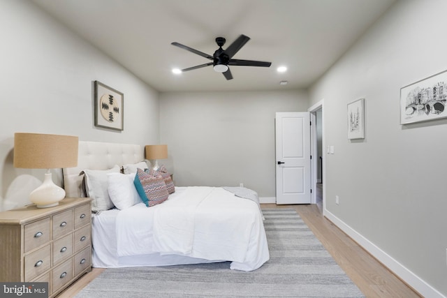 bedroom with ceiling fan and light hardwood / wood-style flooring