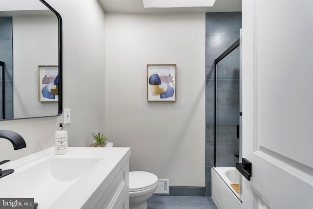 full bathroom featuring vanity, enclosed tub / shower combo, and toilet