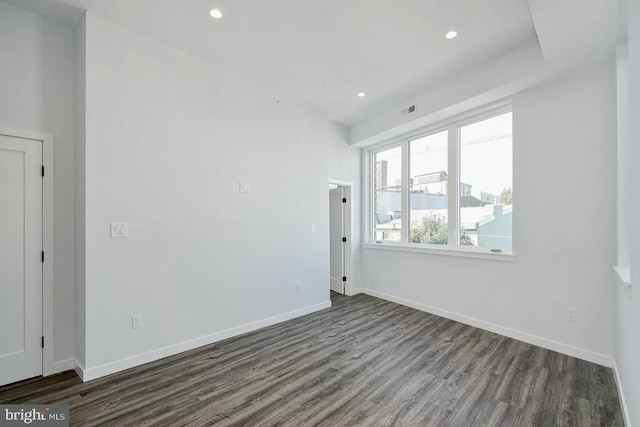 empty room with dark wood-type flooring