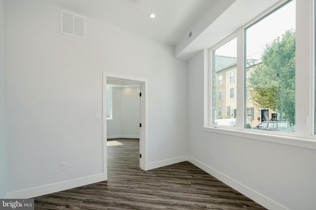 spare room with dark wood-type flooring