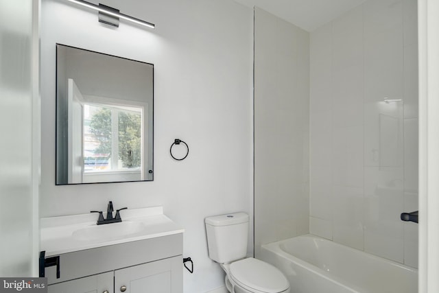 full bathroom with tiled shower / bath, vanity, and toilet