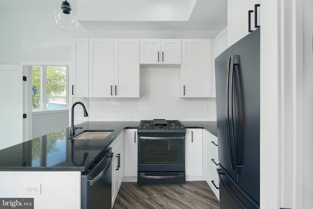 kitchen with dark hardwood / wood-style flooring, white cabinetry, sink, and black appliances