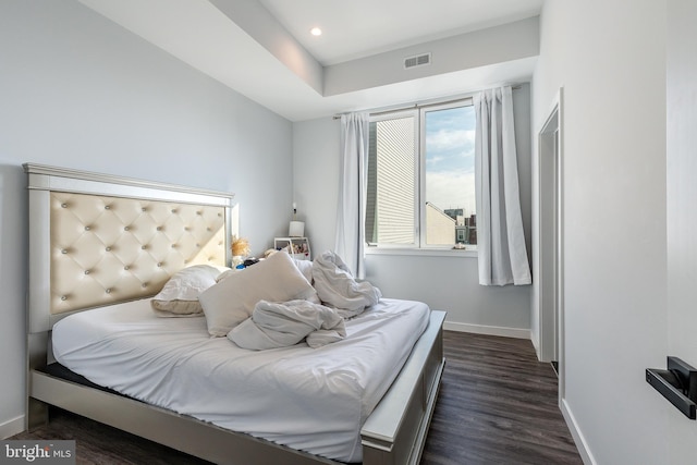 bedroom with dark wood-type flooring