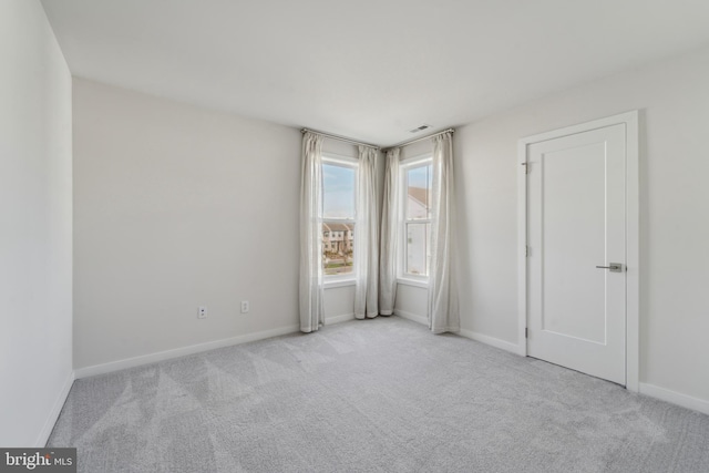 unfurnished room with light colored carpet