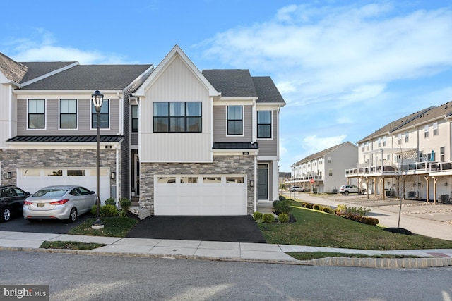 view of property with a garage and a front yard