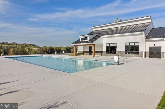 view of swimming pool with a patio area