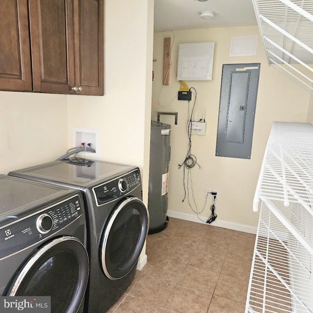 laundry room with cabinets, water heater, electric panel, light tile patterned floors, and washer and dryer