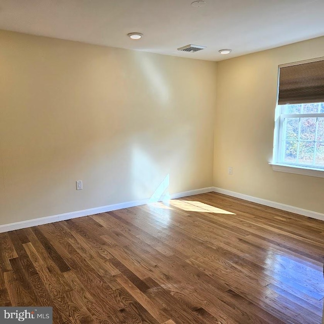 spare room with wood-type flooring