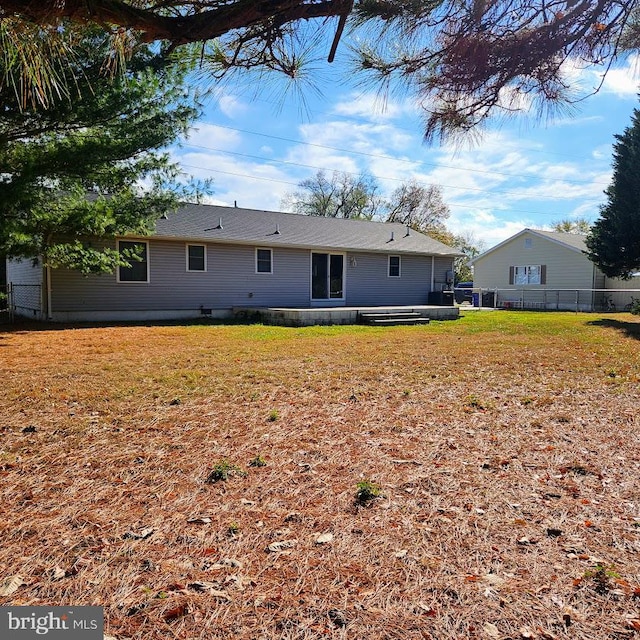 back of house with a yard