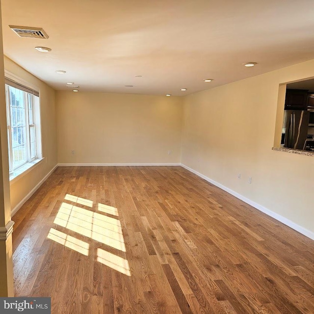 spare room featuring wood-type flooring