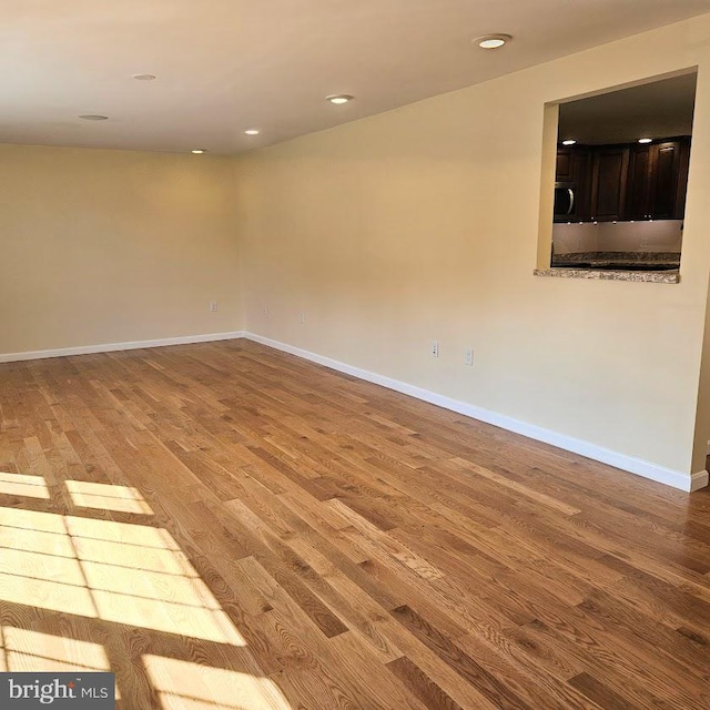 unfurnished room with wood-type flooring