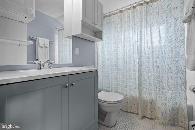 full bathroom featuring tile patterned floors, vanity, toilet, and shower / bathtub combination with curtain