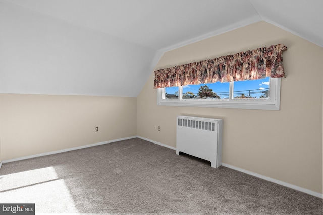 bonus room with carpet flooring, radiator, and vaulted ceiling