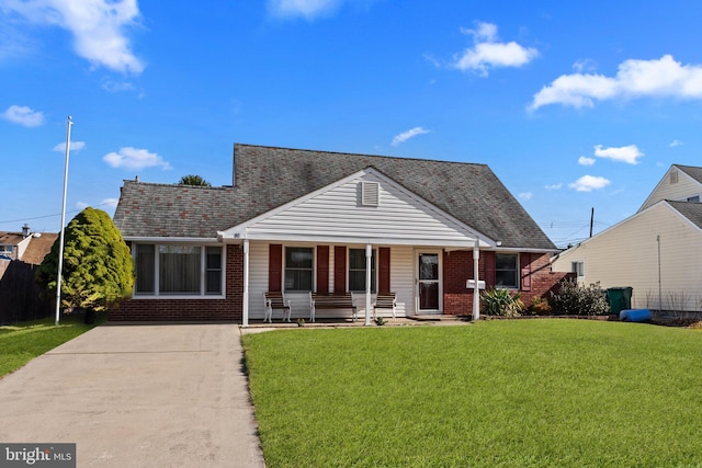 bungalow-style house featuring covered porch and a front yard