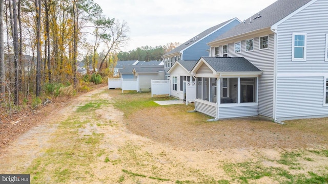 back of property with a sunroom