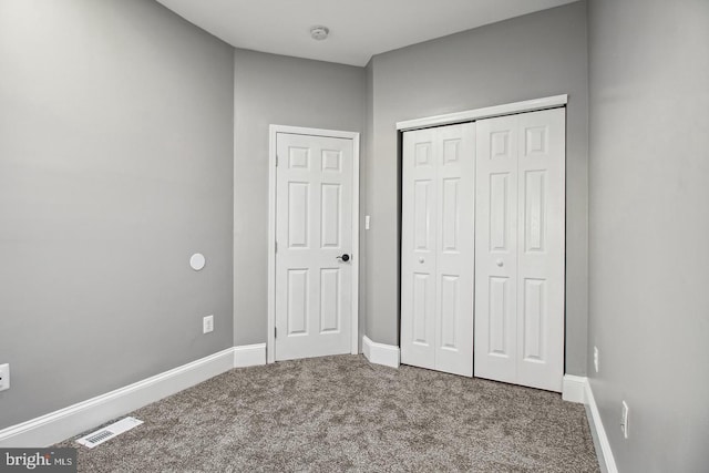 1806 E Lafayette Ave, Baltimore, MD 21213 - unfurnished bedroom featuring carpet flooring, a closet, and baseboards