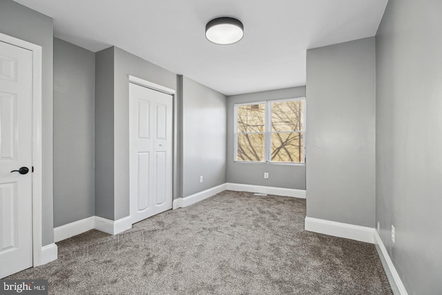 1806 E Lafayette Ave, Baltimore, MD 21213 - unfurnished bedroom featuring carpet, a closet, and baseboards