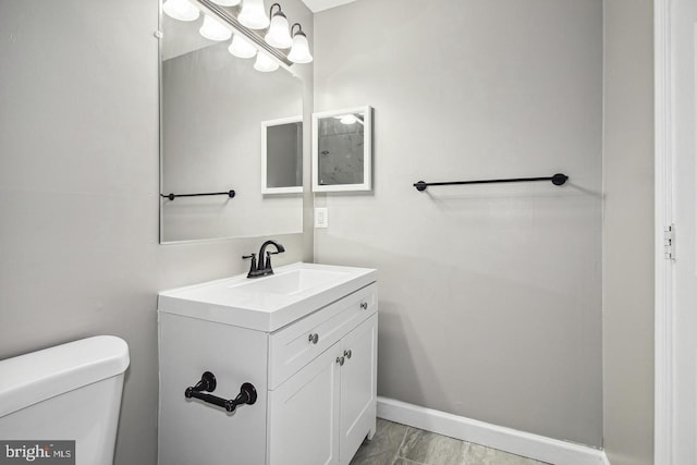1806 E Lafayette Ave, Baltimore, MD 21213 - bathroom with toilet, vanity, marble finish floors, and baseboards