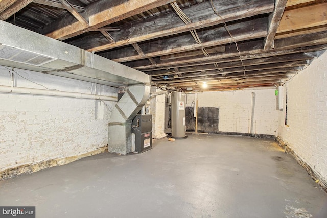 basement featuring electric water heater and heating unit