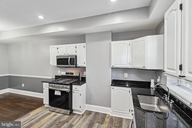 1806 E Lafayette Ave, Baltimore, MD 21213 - kitchen featuring appliances with stainless steel finishes, a sink, dark wood-style flooring, white cabinetry, and recessed lighting