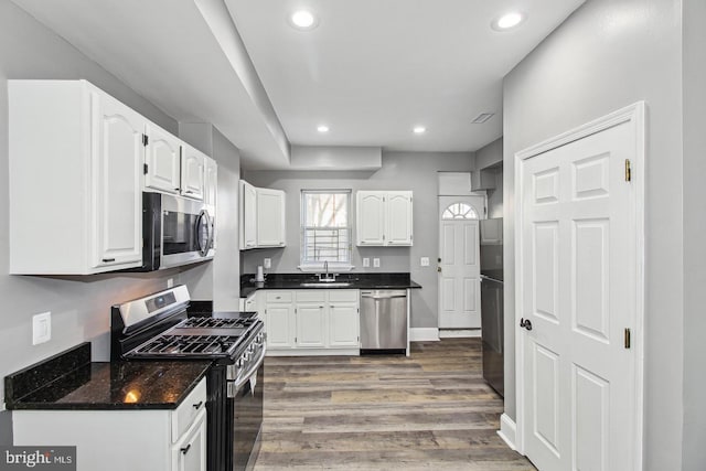1806 E Lafayette Ave, Baltimore, MD 21213 - kitchen featuring appliances with stainless steel finishes, white cabinets, a sink, recessed lighting, and wood finished floors