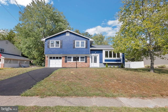 split level home featuring a front yard and a garage