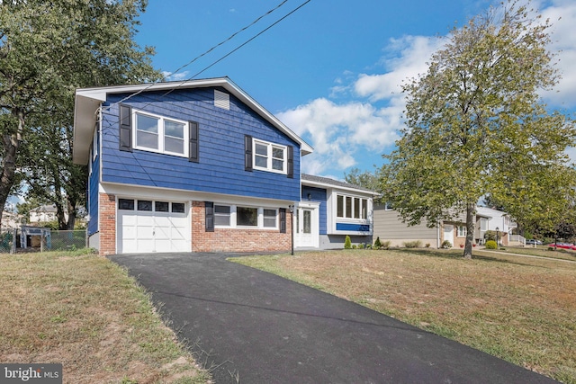 tri-level home with a front yard and a garage