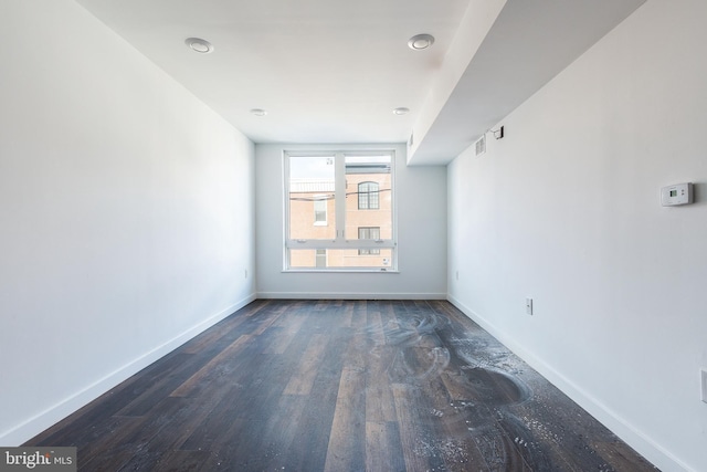 unfurnished room featuring dark hardwood / wood-style floors