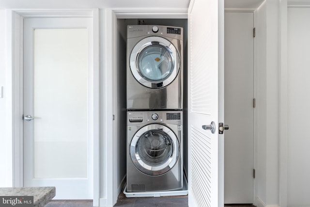 washroom featuring stacked washer and clothes dryer