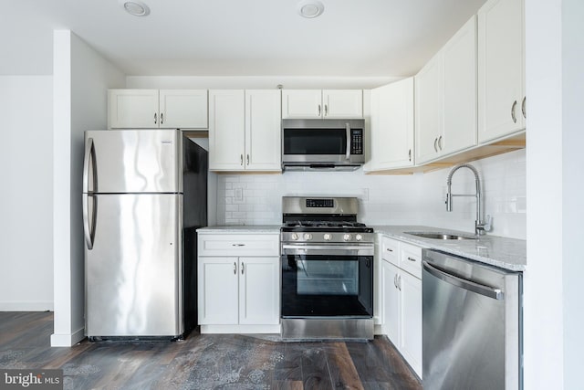 kitchen with sink, white cabinets, stainless steel appliances, and dark hardwood / wood-style floors