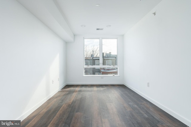 unfurnished room featuring dark hardwood / wood-style flooring