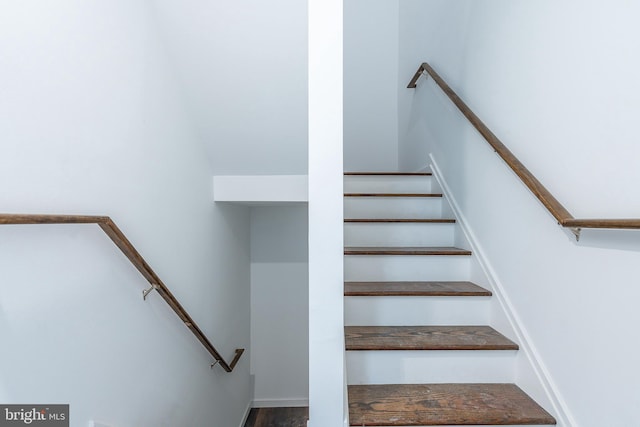 stairs featuring hardwood / wood-style flooring