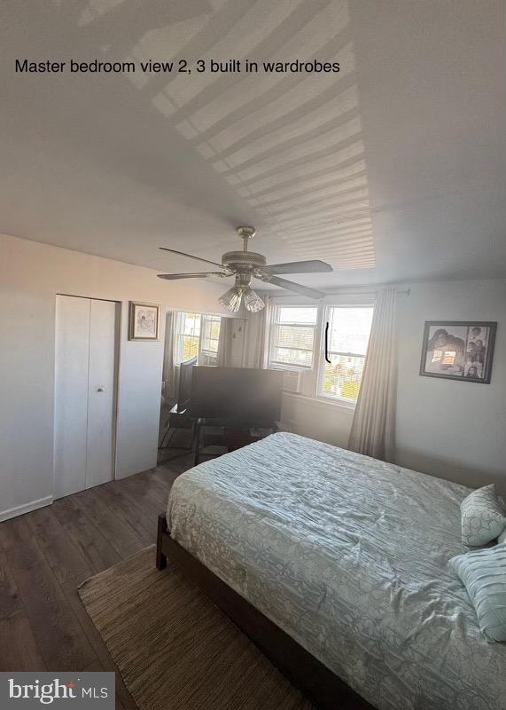 bedroom featuring a closet, ceiling fan, and dark hardwood / wood-style flooring